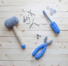 two crocheted objects sitting on top of a wooden table next to screws and nails