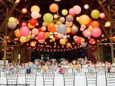 the tables are set up with paper lanterns hanging from the ceiling