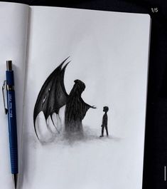 an open book with a drawing of a man and a dragon on it next to a pen