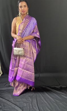 Indulge in the epitome of elegance with our exquisite Kanchipuram hand-tied bandhej saree collection from The Chic Tale. Drape yourself in the rich heritage of Kanchipuram silk, meticulously hand-crafted by our skilled artisans. Each saree is a masterpiece, showcasing intricate patterns and vibrant hues that will leave you mesmerized. Embrace the timeless beauty of these sarees and add a touch of luxury to your wardrobe. Shop now at The Chic Tale and experience the allure of Kanchipuram hand-tied bandhej sarees. The saree comes with Silk Mark and is ready to wear with falls, pico and beautiful tassels , and blouse piece fabric. Saree comes in a beautiful saree cotton bag. Note: Colors that show up on your screen may vary slightly from the actual product due to variations in settings. Also, Purple Pre-draped Saree With Cutdana For Traditional Ceremonies, Traditional Purple Tissue Silk Pre-draped Saree, Purple Handloom Pre-draped Saree, Elegant Paithani Silk Pre-draped Saree For Traditional Ceremonies, Traditional Chanderi Wear With Tilla For Puja, Semi-stitched Saree With Tilla For Puja, Bollywood Art Silk Saree With Tilla, Bollywood Style Art Silk Saree With Tilla, Pre-draped Tissue Silk Saree With Cutdana For Traditional Ceremonies