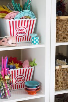 the shelves are filled with toys and other items for playrooms, such as popcorn