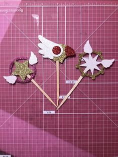 three pieces of crafting paper on a cutting board