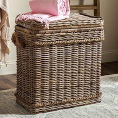 a wicker basket with a pink blanket on top