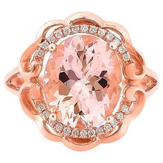 a ring with an oval cut pink diamond surrounded by smaller round diamonds in rose gold