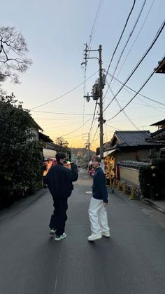 two men are walking down the street together