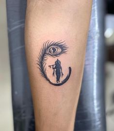 a person with a tattoo on their leg and an eye in the background is shown