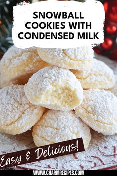 snowball cookies with condenseed milk are stacked on top of each other in front of a christmas tree