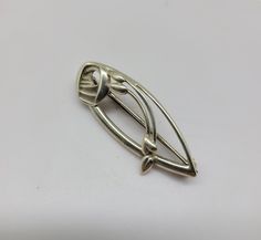 A silver celtic brooch in an art nouveau and geometric Glasgow rose style. Made by Ola Gorie. Measures 1.6cm x 4.2cm Geometric Brooch, Celtic Brooch, Rose Brooch, Rose Style, Style Art, Silver Roses, Glasgow, Brooch Pin, Brooches