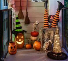 a porch decorated for halloween with pumpkins and witch hats