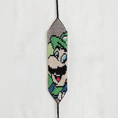 the beaded tie is decorated with an image of luigi