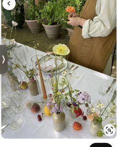 there are many flowers in vases on the table