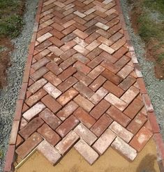 a brick walkway is being laid out on the ground