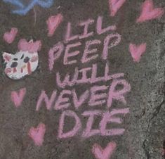 graffiti written on the side of a sidewalk with hearts and a small cat in it