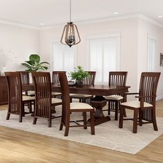 a dining room table with chairs and a potted plant