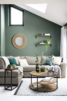 a living room with green walls and white rugs on the floor, two couches in front of a round coffee table