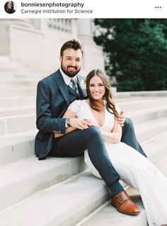 a man and woman are sitting on the steps posing for their wedding photo in front of some stairs