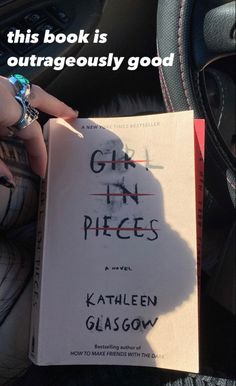 someone holding a book in their hand with the title girl in pieces written on it