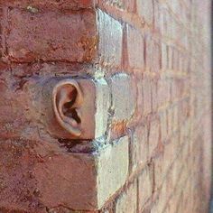 a brick wall with an ear on it