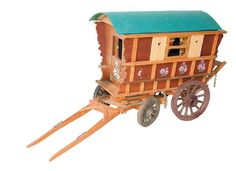 a wooden horse drawn carriage with green roof