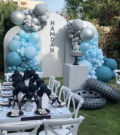 a table set up with balloons and decorations for a birthday or baby's first birthday