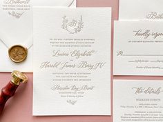 the wedding stationery is laid out on top of each other, including a wax stamp