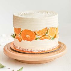 a white cake with orange slices on it