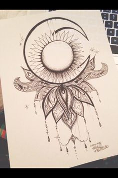 a drawing of the moon and sun with an intricate design on it's side