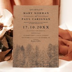 a brown wedding card with white flowers on it