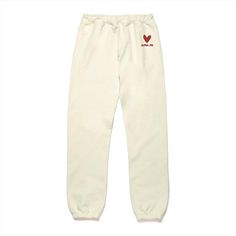 a pair of white sweatpants with red heart embroidered on the side