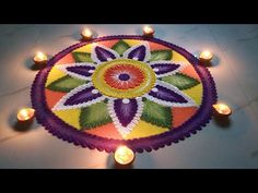 a colorful rangdi with candles on the floor