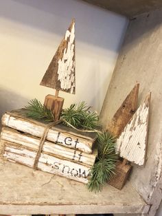 a wooden christmas tree sitting on top of a shelf