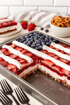 an american flag dessert with strawberries, blueberries and pretzels on the side