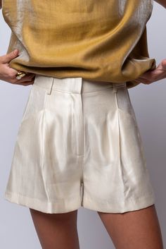 Meet our High Waisted Pleated Metallic Shorts. The sheered metallic material adds a touch of glamour, while the elastic back waist ensures a comfortable fit. Features front zip and hook and eye closure, front pockets, and belt loops. Perfect for a chic and flattering fit and flair look. Hand Wash Cold Import 84% Rayon | 10% Polyester | 6% Nylon Fit Guide: Libby is 5ft 9 inches; Bust 34”, Waist 25”, Hips 34” Model is wearing a small True to size *available at our Bandit location Lavender Brown, Metallic Shorts, Katie May, Kimono Duster, Brown Line, Capri Blue, Mink Pink, Blue Moon, Outerwear Jackets