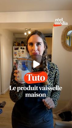 a woman holding a glass with milk in it and the words tuto le produit vaiselle maisonon