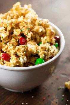 a white bowl filled with cereal and candy canes on top of a wooden table