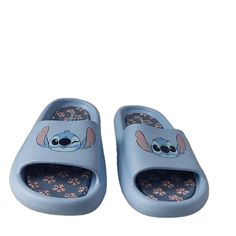 Step Into The Magical World Of Disney With These Stylish Flip Flops Featuring Stitch And A Blue Floral Pattern. Slip Them On With Ease, Thanks To Their Lightweight Design And Flat Heel Style. Perfect For Women Who Love Sandals, These Rubber-Made Shoes Are Part Of The Disney Product Line And Feature A Cute Logo Accent. The Shoes Come In Size 11 For Us Shoe Size And 9.5 For Uk Shoe Size, With An Eu Shoe Size Of 40.5 And An Au Shoe Size Of 10.5. They Are Not Customized And Are Not Vintage. Add Thes Cute Blue Sandals For Vacation, Blue Non-slip Slides For Vacation, Non-slip Blue Slides For Vacation, Cute Blue Round Toe Sandals, Light Blue Synthetic Slides With Round Toe, Cute Non-slip Blue Sandals, Blue Non-slip Slippers For Vacation, Casual Non-slip Flip Flops For Playtime, Blue Non-slip Open Toe Slippers