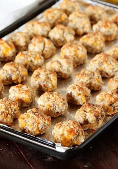 a pan filled with lots of food on top of a wooden table