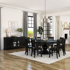 a dining room table with chairs and a rug on the floor