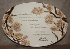 a white plate with gold leaves on it and a poem written in the center that says give thanks