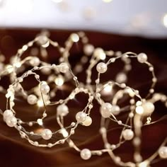 some white pearls and lights on a table