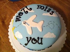 a birthday cake with an airplane on it that says, we're miss you