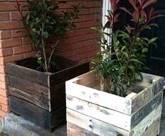 two wooden planters sitting on the front steps