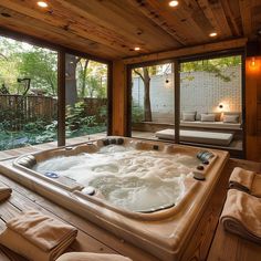 a large jacuzzi tub sitting inside of a wooden room next to a patio