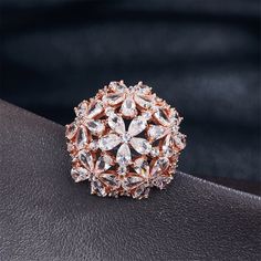 Accessorize your ensembles and add some sparkle to your hands with this rose gold-plated ring featuring cubic zirconia accents and a floral ball design. ?Face: 0.98'' W x 0.98'' H 18k rose gold-plated copper / cubic zirconia Rose Gold Cubic Zirconia Flower Jewelry, Luxury Rose Gold Brooch Jewelry, Luxury Rose Gold Cubic Zirconia Flower Ring, Luxury Rose Gold Cubic Zirconia Crystal Ring, Rose Gold Flower-shaped Cubic Zirconia Earrings, Clover Ring, Ball Design, Plated Ring, 18k Rose Gold