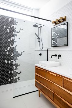 a bathroom with two sinks and a shower