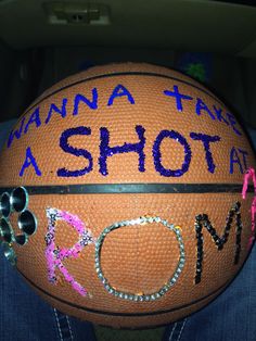 a close up of a person holding a basketball with words written on the inside of it