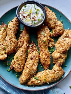 chicken wings with ranch dressing on a blue plate