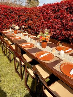 an outdoor table set with place settings and plates for eight people to enjoy the meal