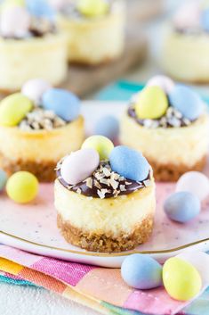 mini cheesecakes with candy eggs on a plate