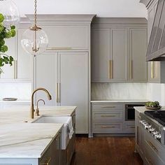 a kitchen with marble counter tops and wooden floors